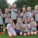 May 2017: Junior Academy Girls pose with their medals from the NTH Adidas Cup tournament.