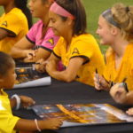 Oct. 6, 2017 KSU vs Jacksonville game: One of our youngest NTH Junior Academy Girls collects player autographs